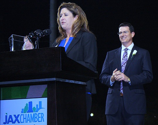 Photo by Joe Wilhelm Jr. - JAX Chamber 2013 Small Business Leader of the Year Vanice Serrano of ASAP Towing &amp; Storage Co. accepts the award at the 128th annual chamber meeting Thursday at the Baseball Grounds of Jacksonville as 2012 winner Chad Pe...