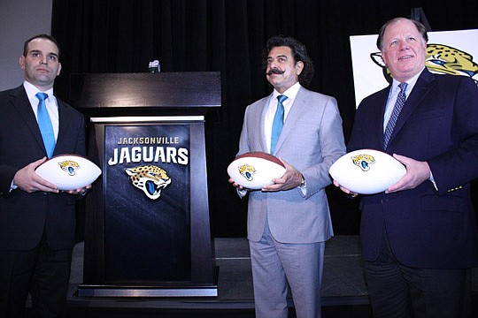 Photos by Joe Wilhelm Jr. - From left, Jaguars General Manager David Caldwell, owner Shad Khan and President Mark Lamping show off the new logo for the Jaguars Tuesday.