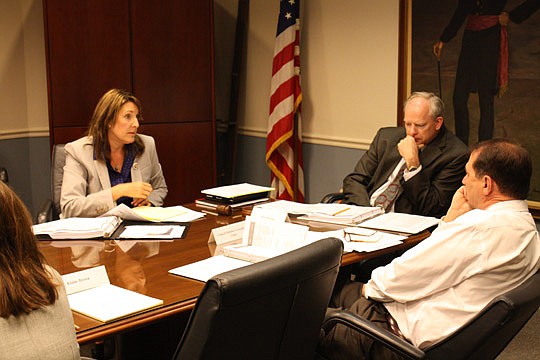 Photo by Joe Wilhelm Jr. - From left, Lisa King, a grant writer and Langton Associates vice president, discusses St. Johns River Ferry grant options with St. Johns River Ferry Commission members Aaron Bowman and City Council member John Crescimbeni.