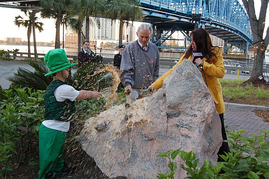 Photos by Max Marbut - Mike Swiedals, Fionn MacCool's General Manager Paul Glaser and Tracy Collins from WAWS TV-30 and WTEV TV-47 broke bottles of Guinness over the Blarney Stone at the Landing this morning to begin Downtown's celebration of St. Patr...