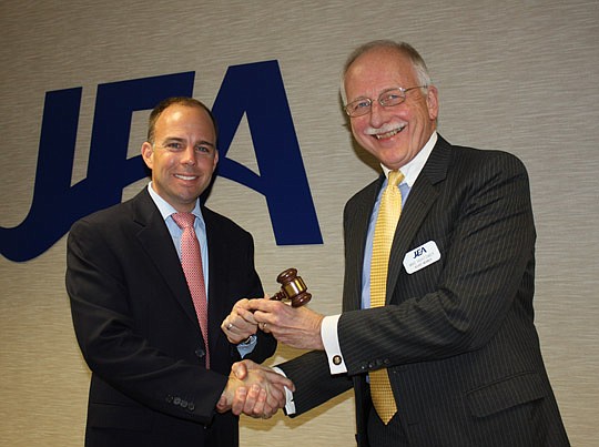 Photos by Joe Wilhelm Jr. - Immediate past JEA board Chair Ashton Hudson passes the gavel to new Chair Mike Hightower. Hightower, Vice Chair Cynthia Austin and Secretary Helen Albee were elected as the board's new officers Tuesday.