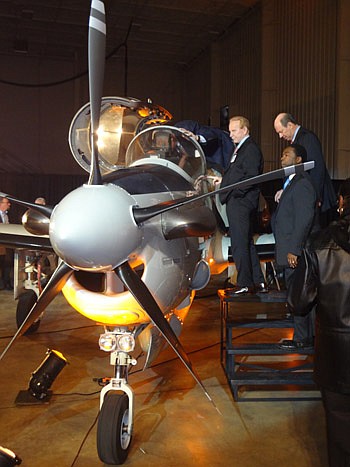 Photo by David Chapman - Jacksonville Aviation Authority board Chair A.L. Kelly, JAXUSA Partnership President and JAX Chamber interim President Jerry Mallot and Mayor Alvin Brown take an up-close look at the A-29 Super Tucano warplane Wednesday.