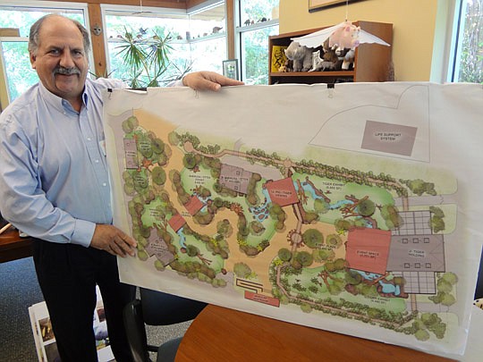 Photos by David Chapman - Jacksonville Zoo &amp; Gardens Executive Director Tony Vecchio holds renderings of what the planned Asia Precinct expansion will look like - additions that include a tigers, pigs, otters and hornbills. The zoo has an $11.5 mi...