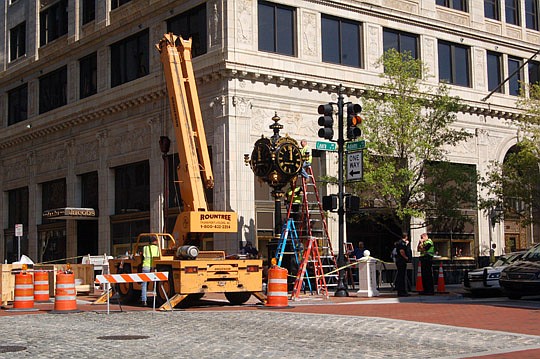 Photos by Max Marbut - The Jacobs Jewelers clock was reinstalled Monday Downtown.