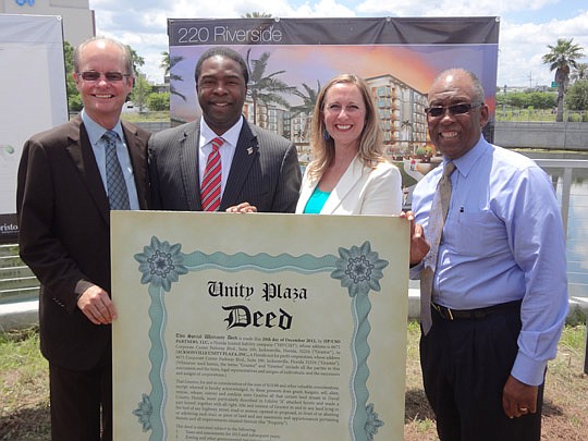 From left, Alex Coley, Hallmark Partners principal and co-founder; Mayor Alvin Brown; Jen Jones, Jacksonville Unity Plaza Inc. executive director; and City Council member Warren Jones gathered during a ceremonial deed transfer for Unity Plaza. As part...