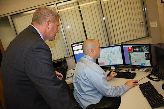 Photos by Joe Wilhelm Jr. - Matt Rapp, executive director of The Players, looks over the shoulder of Ryan Crist, Florida Department of Transportation District No. 2 Traffic Management Center manager, on Tuesday as he shows how cameras can be adjusted....