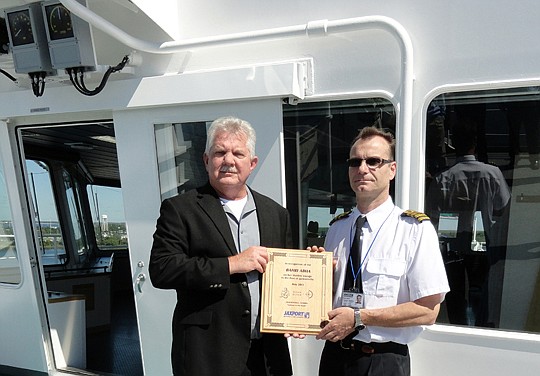 JaxPort Operations Manager Steve Kapustka presents a maiden-voyage plaque to Capt. Alen Knego of the vessel Bahri Abha during its first call.