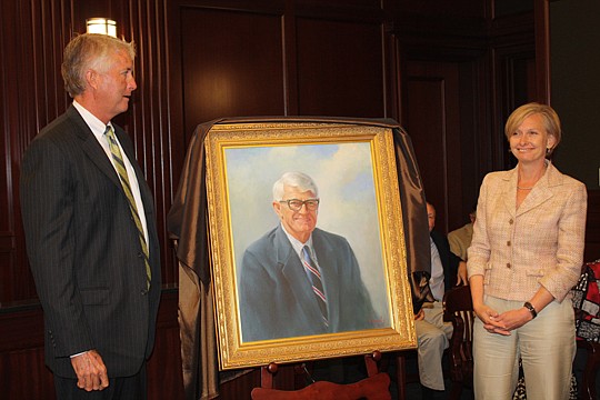 Photo by Joe Wilhelm Jr. - Former Mayor Ed Austin's son, Steve Austin, and daughter, Amy Slater, view a portrait of their father. The portrait will be hung near the entrance of the Ed Austin Courtroom at the Duval County Courthouse.
