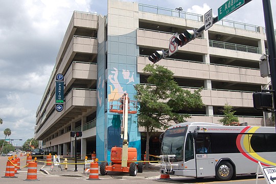 Murals are being painted on the Yates Building parking garage along East Adams Street. The project is part of the City's Art in Public Places program.