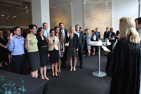 Photo by Joe Wilhelm Jr. - Circuit Judge Virginia Norton swears in the 2013-14 The Jacksonville Bar Association Young Lawyers Section board of governors Thursday at the Museum of Contemporary Art Downtown. Board members are (from left) Beau Baker, Ren...