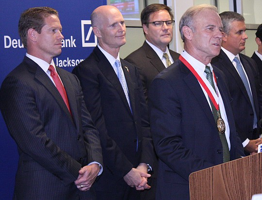 Photo by Joe Wilhelm Jr. - From left, Daniel Davis, state Rep. and incoming JAX Chamber president and CEO; Gov. Rick Scott; state Sen. Aaron Bean; and Michael Drexler, managing director of investment banking and trading for Deutsche Bank Jacksonille, ...
