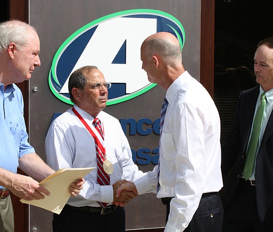 Photo by Joe Wilhelm Jr. - Charlie Appleby (center), Advanced Disposal chairman and CEO, received Gov. Rick Scott's Business Ambassador award Monday at the grand opening of the company's new headquarters in the Nocatee area of Ponte Vedra. The company...