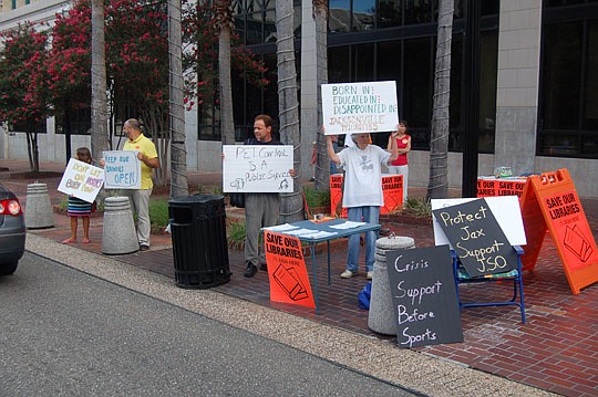 Photo by Max Marbut - People stood outside City Hall on Monday morning to protest potential service cuts presented in Mayor Alvin Brown's budget.