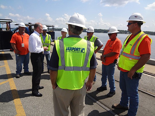 Photos by David Chapman - Jacksonville Port Authority CEO Brian Taylor (second from left) talks with JaxPort workers Tuesday. Taylor began his leadership position with the port Monday.
