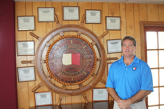 Photo by Joe Wilhelm Jr. - Capt. Tim McGill stands by the master mariner certification letters for bar pilots of the St. Johns Bar Pilots Association. McGill is the president and CEO of the association that supplies expert guides to ensure the safe na...