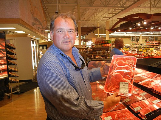 Rob Rowe intends to open his fifth area Rowe's IGA Supermarket this month at 8299 W. Beaver St. He is shown above at the Dunn Avenue and New Kings road store that opened last year.