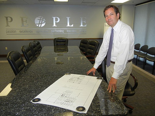 Dixon Hughes Goodman managing partner Lance Windley shows plans for the new office space Downtown.