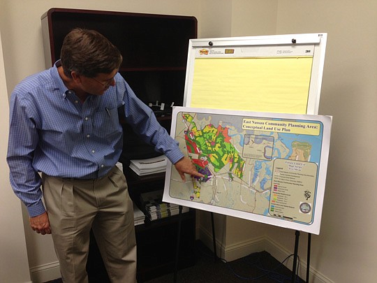 Daniel Camp is the director of project management for TerraPointe Services, working from the company's Fernandina Beach offices. He shows the plan for the East Nassau Community Planning Area that an economic development executive says could become the...
