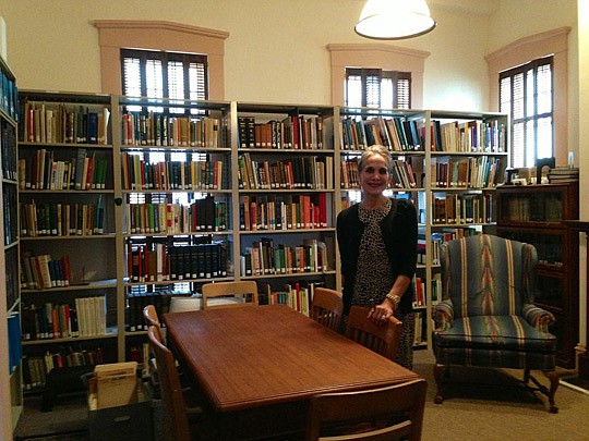 Photo by Tracy Jones - Emily Lisska stands in the library of the Old St. Luke's Hospital on Palmetto Street. The old hospital is one of four buildings occupied by the Jacksonville Historical Society.