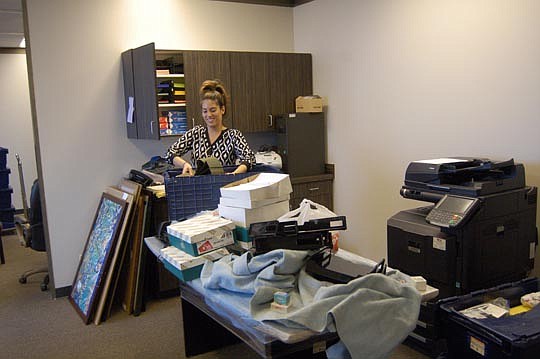 Carla Ortiz, continuing legal education and events coordinator at The Jacksonville Bar Association, was unpacking boxes Tuesday after the organization moved from the Aetna Building on the Southbank to Wells Fargo Center at 1 Independent Drive.
