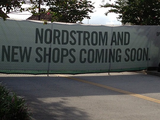 A banner provides a barrier to the construction site for Nordstrom and more shops at St. Johns Town Center.