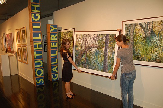 From left, volunteers Kristin Buechelmaier and Allie Gloe were busy in the Dyal-Upchurch Building taking the artwork off the walls this week at Southlight Gallery to prepare for the arts organization's relocation to a space along Hogan Street.