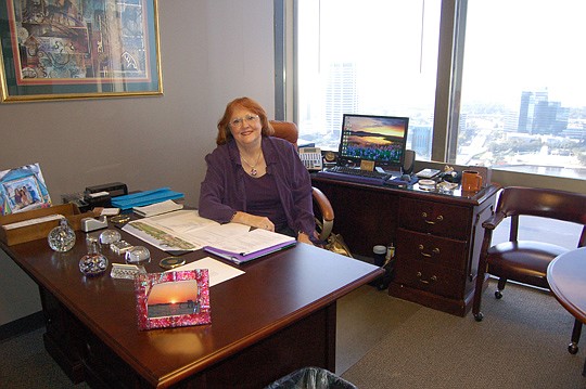 The Jacksonville Bar Association Executive Director Susan Sowards in her office with a view of the Southbank skyline.