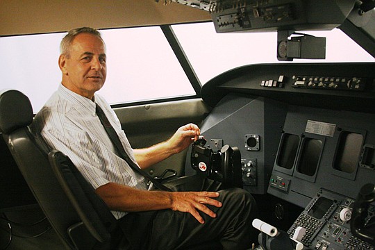 Mark Willette in the Jacksonville University flight simulator, the Davis Aviation Center's $500,000 state-of-the-art teaching tool that enables students to simulate flying for commercial airlines