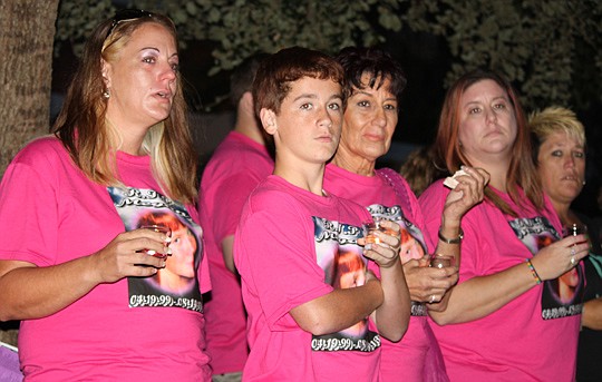 Kylie Simmons (left), the mother of Megan Simmons, was surrounded by family and friends during Monday night's 18th annual Unity Plaza ceremony to honor young people who were victims of violence. Megan and her friend, Jazmine Shelton, were killed in a ...