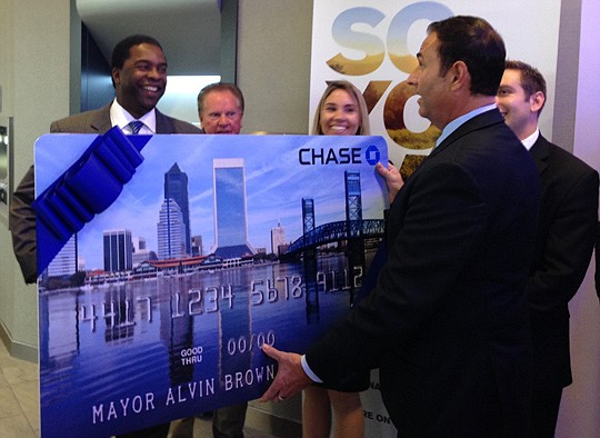 Steve Vachon, Chase's market leader for Jacksonville, presents a giant debit card to Mayor Alvin Brown during the opening of a new branch on Southside Boulevard. The branch is one of three in Jacksonville that Chase opened Tuesday.