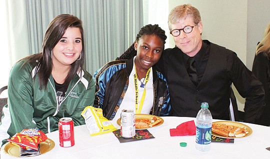Alysia Walker (left) and Mikayale Arline with Jacksonville Symphony Orchestra principal trombonist Jeffery Peterson at the Pizza with the Players event after the symphony's Friday concert. Students gathered for a pizza party lunch with the musicians, ...