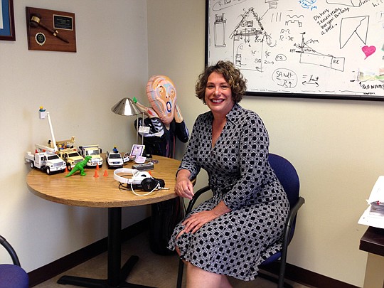 Photo by Tracy Jones - Gerri Boyce, spokeswoman for JEA, works hard but likes to have fun by integrating bright, entertaining objects into her office.