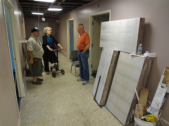 Len (right) and Suzie Loving (middle) discuss details of an under-construction wing of the Five Star Veterans Center with volunteer maintenance worker and veteran Mike Petty. The Lovings operate the veterans center, which is being revamped with help b...