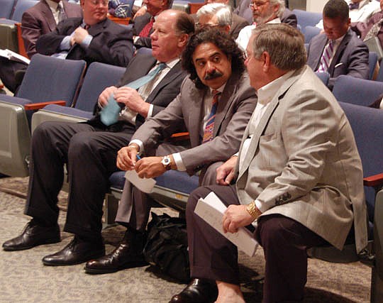 Jacksonville Jaguars owner Shad Khan (center) talks to lobbyist Paul Harden before the City Council meeting began this morning. At left is Jaguars President Mark Lamping.