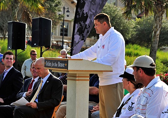 Retired Army Capt. Joe Caley addresses the crowd during The Players' Birdies for the Brave tournament opening ceremony Monday on the lawn at TPC Sawgrass in Ponte Vedra Beach.