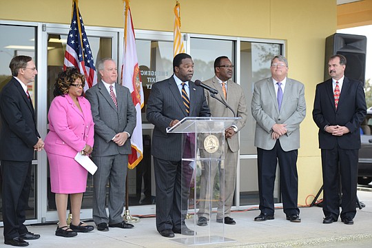 Mayor Alvin Brown (at podium) announces the city has come to agreement with Gateway Shopping Center's owners to extend a lease for the Tax Collector's Office branch housed there. Functions of the branch will be moved Downtown and in its place will be ...