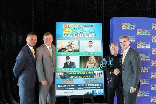 Ted Carter, city Office of Economic Development executive director; Alan Verlander, city Sports and Entertainment director; Quint Davis, Festival Productions Inc. CEO; and Doug Thornton, SMG executive vice president of stadiums and arenas. The group a...