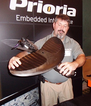 John Curtis, customer project manager for Gainesville-based Prioria Embedded Intelligence, demonstrates the company's Maveric, a portable unmanned aircraft system with bendable wings that enables the deviceÂ to be stored in a 6-inch-diameter tube.