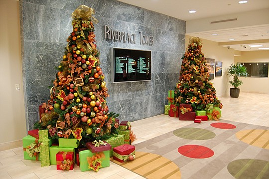 Two Christmas trees are placed near the west concourse entrance at Riverplace Tower on the Southbank.