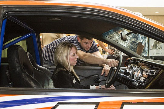Foundation representative Brad Butler shows points out features to Angie Vennerstorm, the mall's director of marketing.