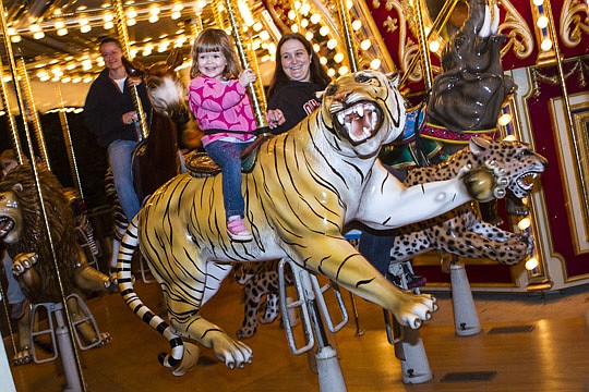 Photos by Bobby King - Erin Sweet and her daughter, Harper Sweet, have a great time on the carousel Saturday at ZOOLights.