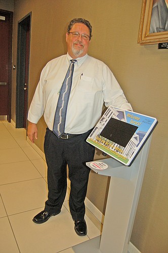 Gerald Cates, information technology director for the Duval County Clerk of Courts, with one of the electronic kiosks jurors use to check in at the courthouse.
