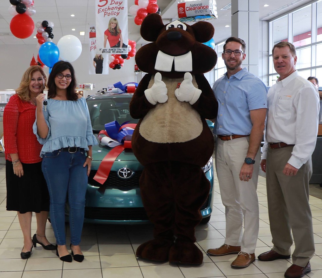 Shelly Davalos, program director at Daniel Kids; Adelina Ferreira, former Daniel Kids client;  Bucky Beaver; Nick Ruether, general manager of Beaver Toyota, and Jon Cummins, AutoPoint director  of technology project management.