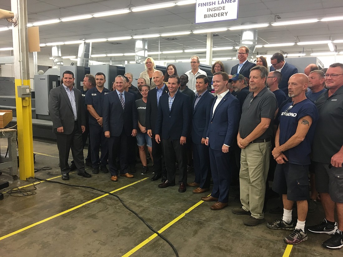 Gov. Rick Scott visited Drummond Press in west Jacksonville on Tuesday in support of his tax proposal.
