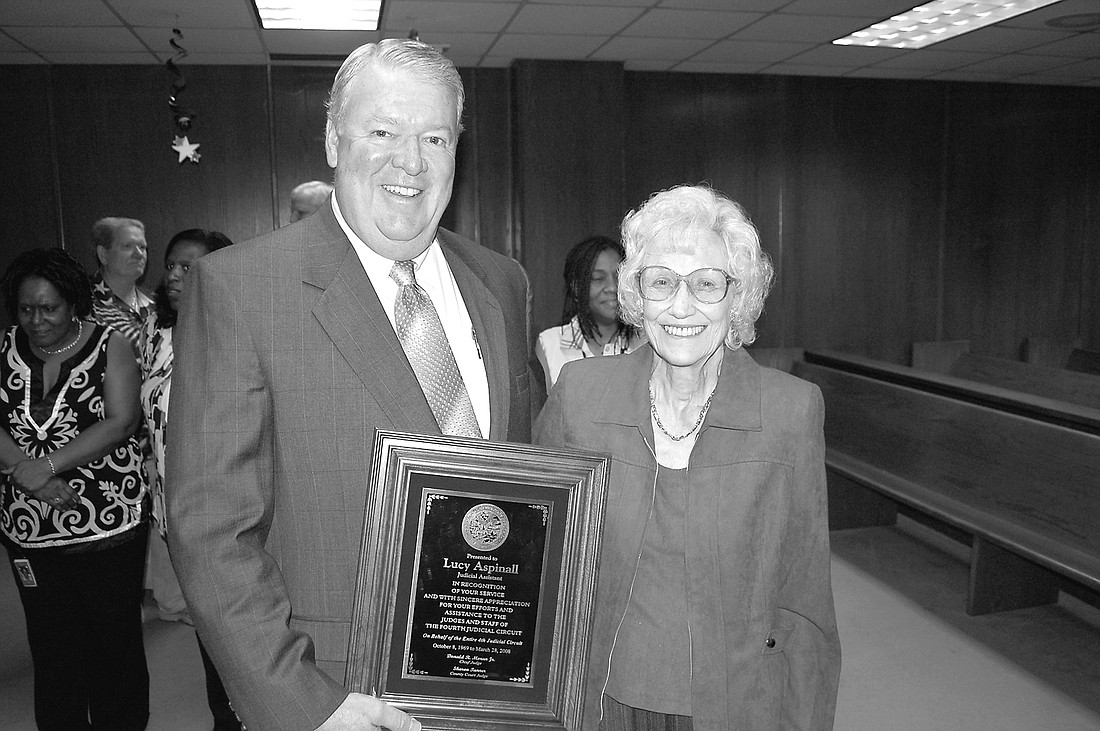 Former Chief Judge Don Moran presents Lucy Mae Aspinall with a plaque on the day she retired in March 2008.