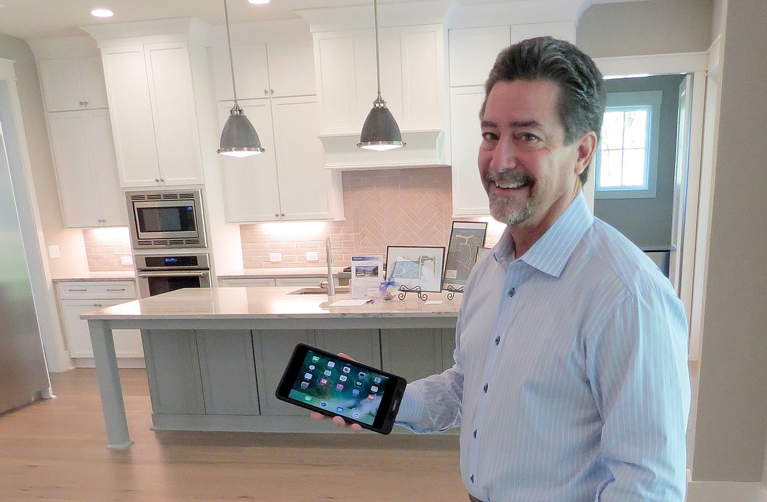 Glenn Layton demonstrates how a smart home can be controlled using a smartphone. In 2013, Layton was selected by HGTV for its first-ever smart home build.