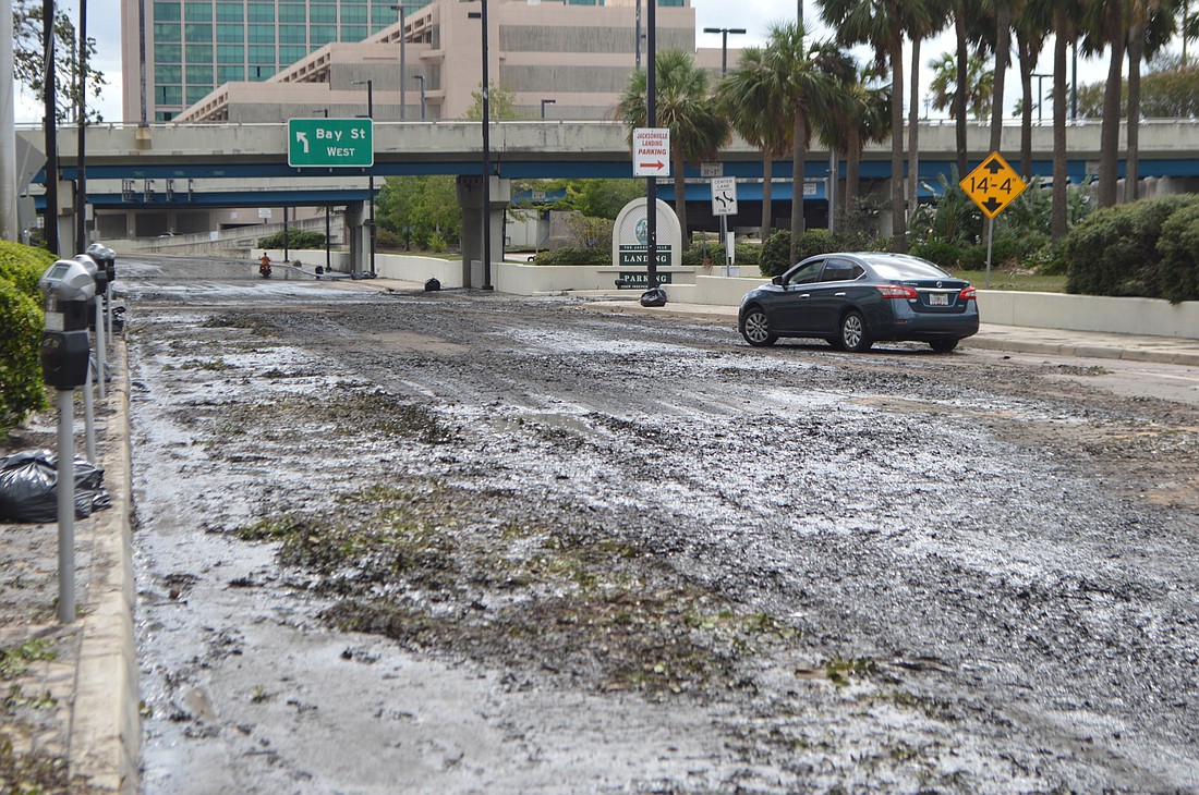Receeding floodwaters leave muddy streets in Downtown Jacksonville. (Photo by David Cawton)