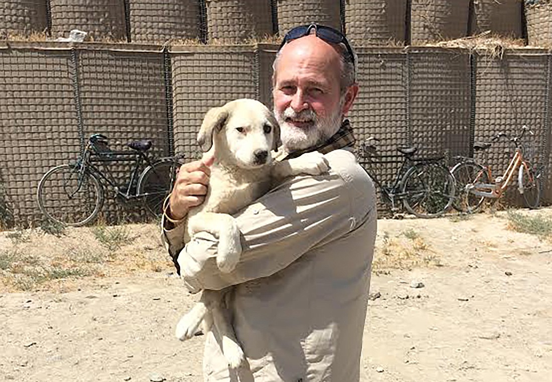 Tatsch in Afghanistan holding a rescue dog with the charity Nowzad, Winning the War for Animals.