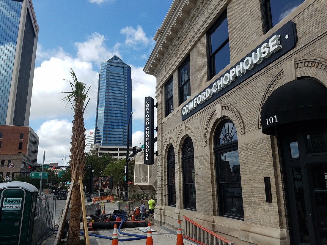 Work continued Thursday outside the Cowford Chophouse at 109 E. Bay St.