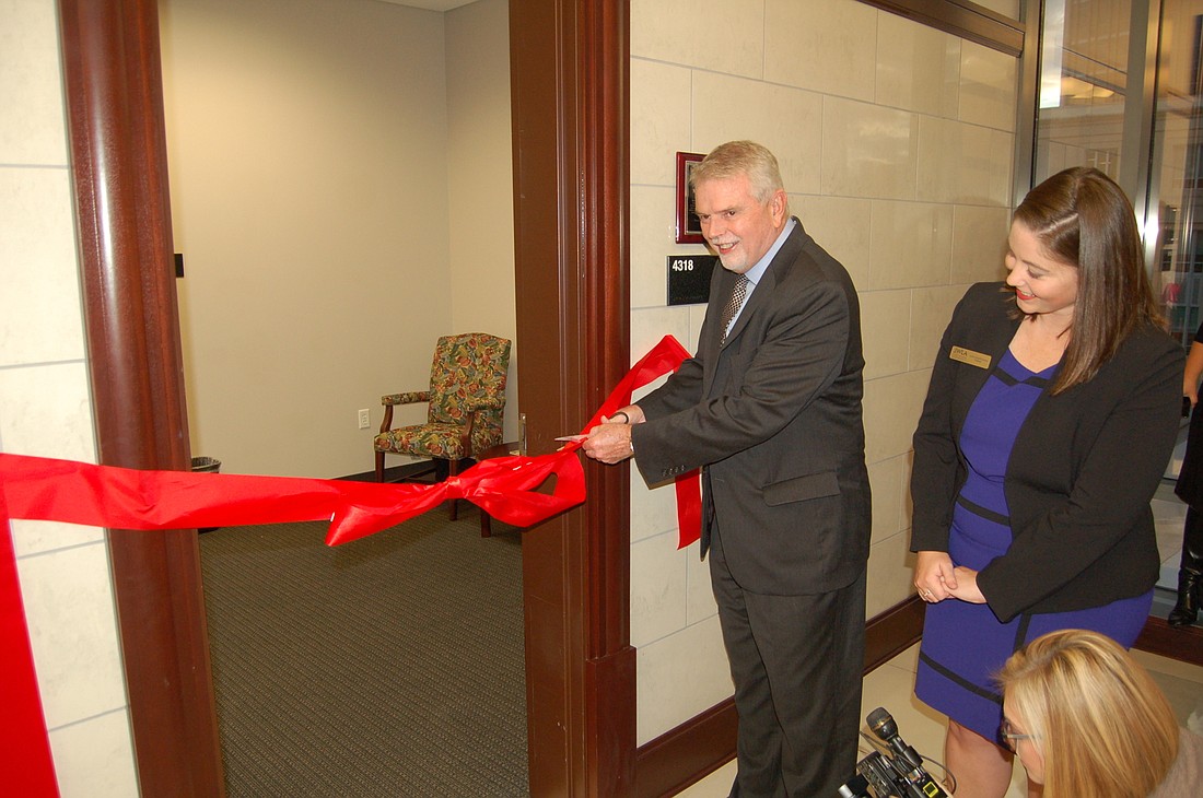 Fourth Judicial Circuit Chief Judge Mark Mahon, witnessed by Jacksonville Women Lawyers Association President Jennifer Shoaf Richardson, cut the ribbon Wednesday to open the Nursing Lounge at the Duval County Courthouse.